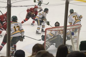 Hockey players from Clarkson University and St. Lawrence University battle in front of Clarkson's net. 