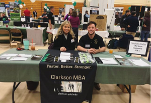 Steven Lewis tabling at a college fair for Clarkson University MBA