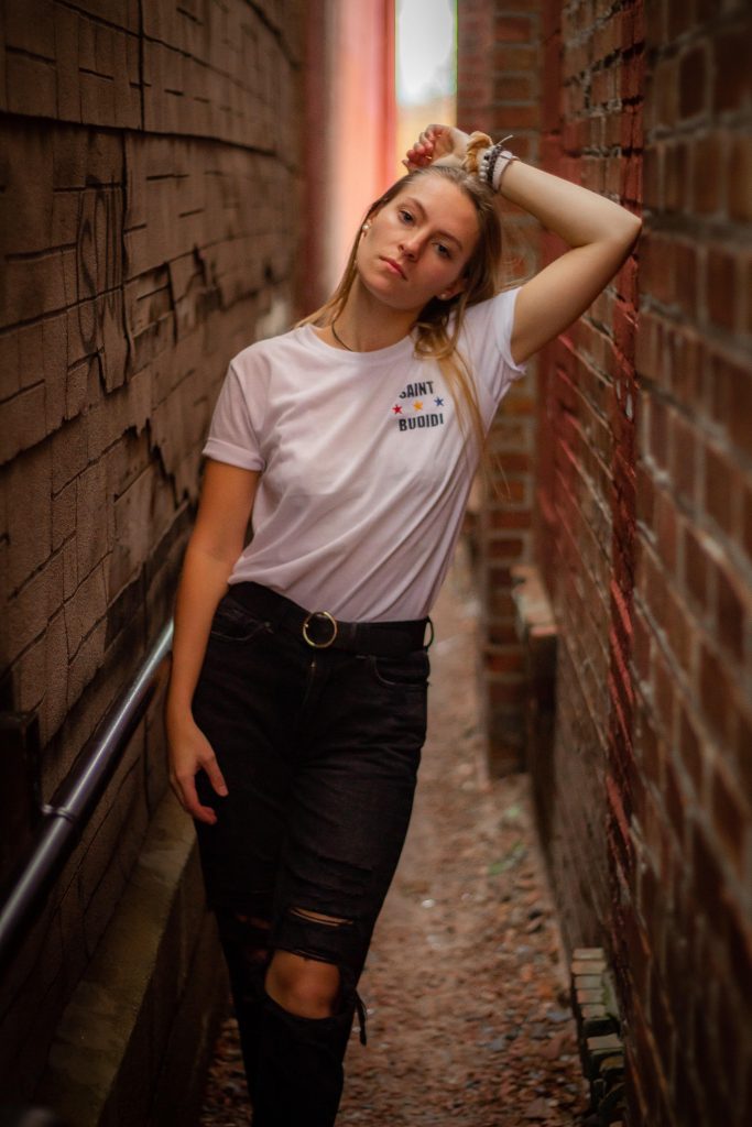 A model has her photo taken in a narrow brick alleyway by Clarkson student Jada Flanagan in downtown Potsdam, New York. 