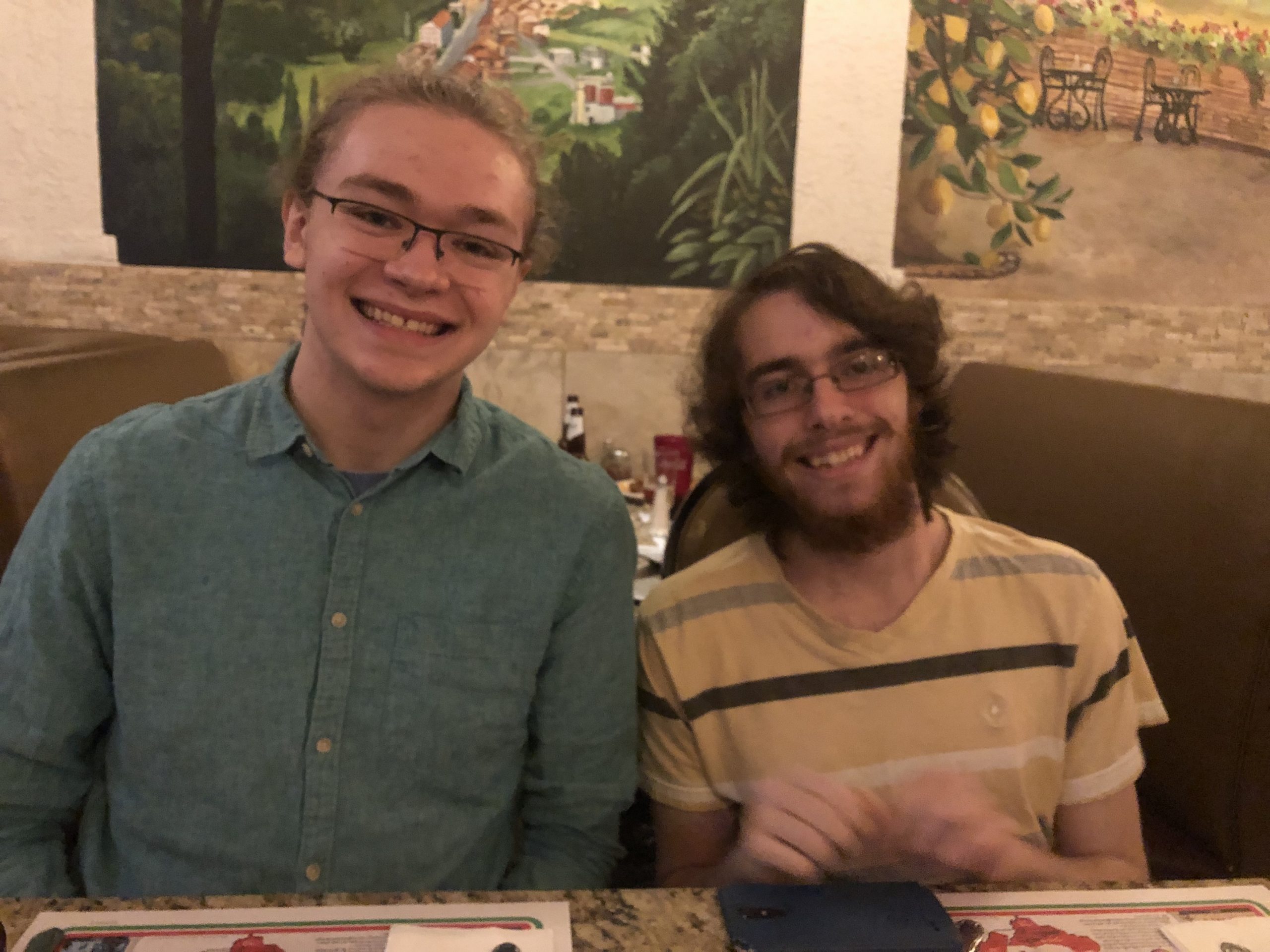 Two people sitting at a table smiling