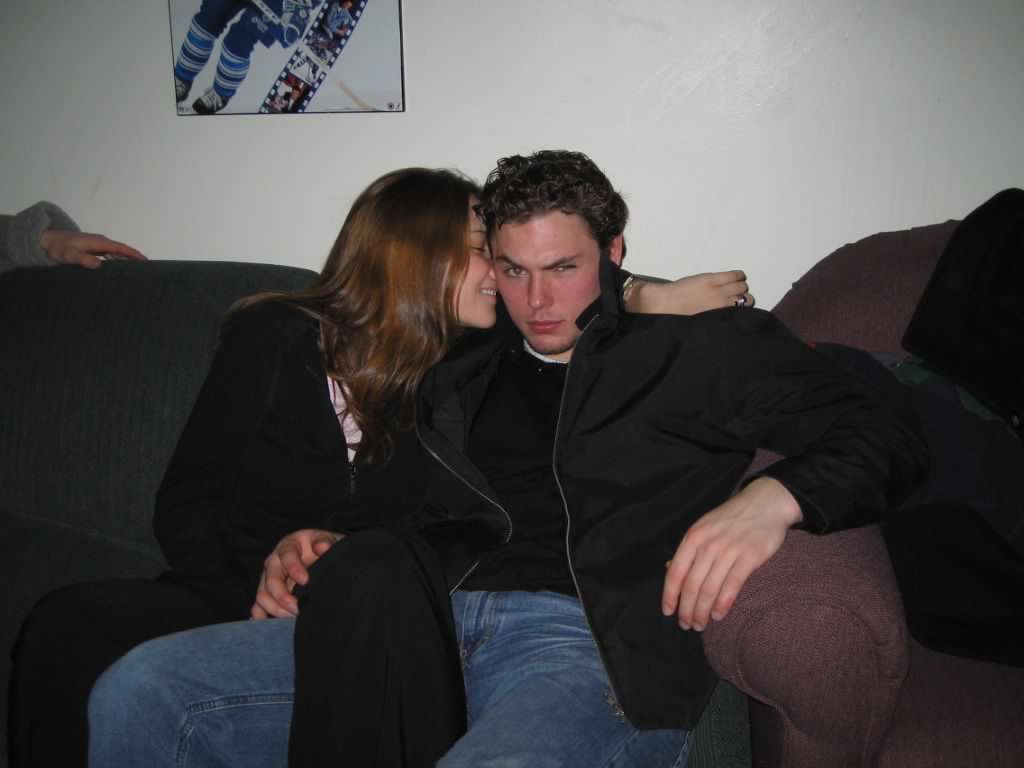 A women looking at a man while sitting on a couch 