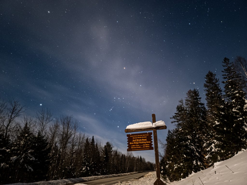 snowy adirondack road with a starry sky 