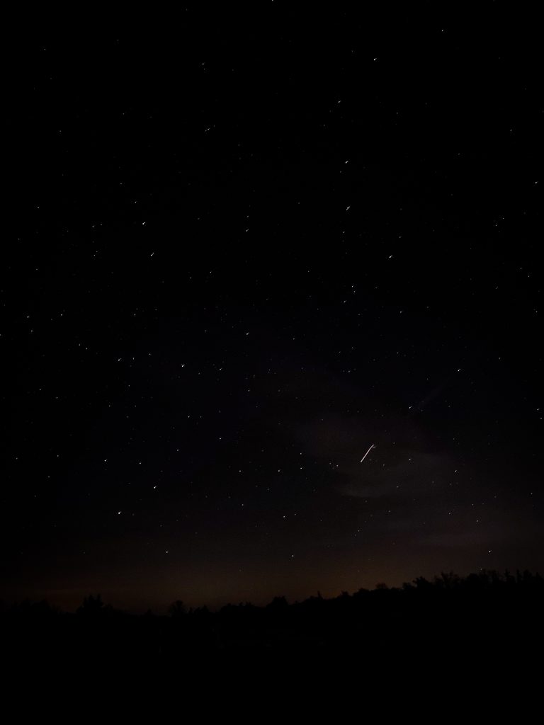 stars with a meteor trail in the lower left hand side