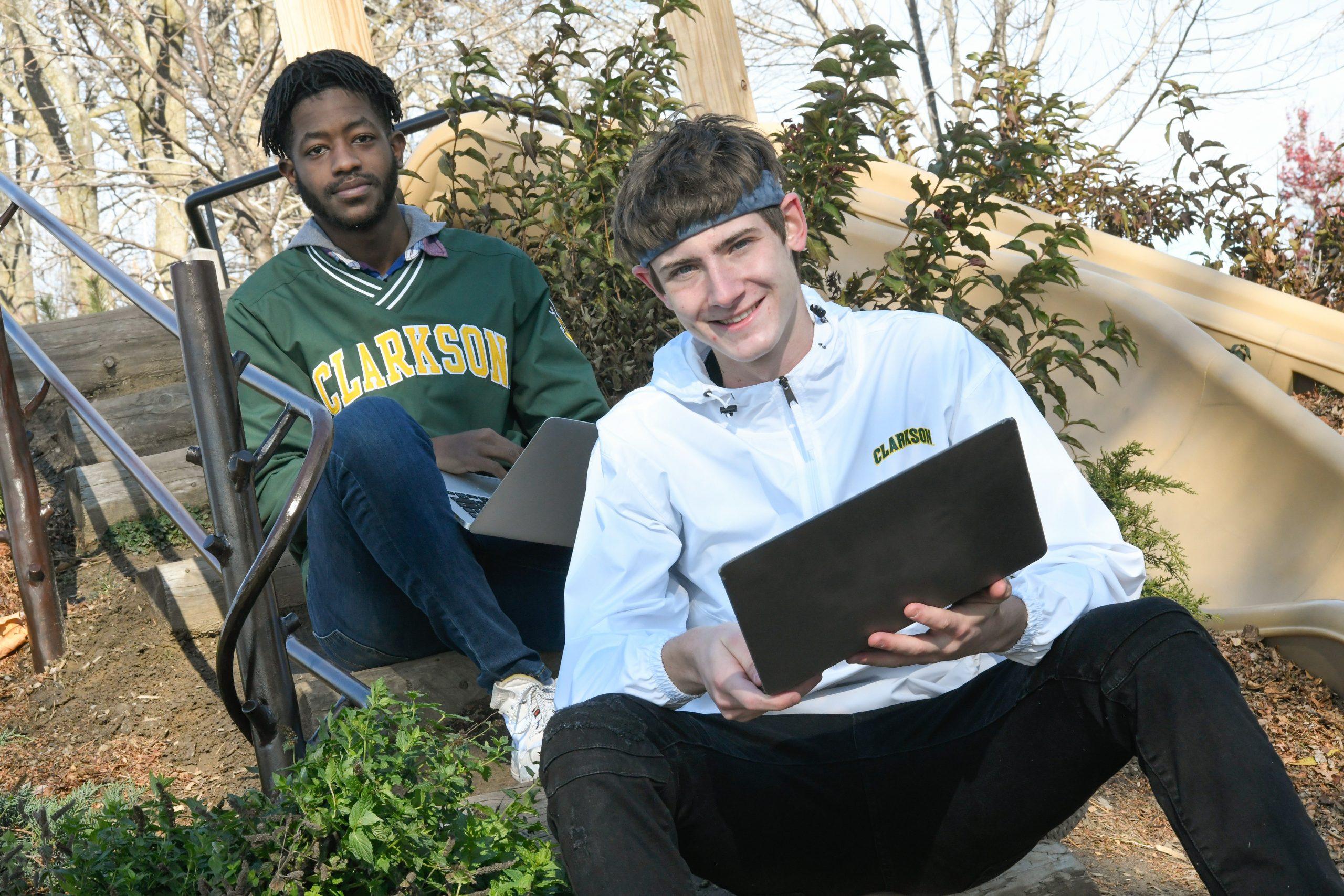 Clarkson student Max Powers poses with his laptop and his business partner Selorm Bruce.