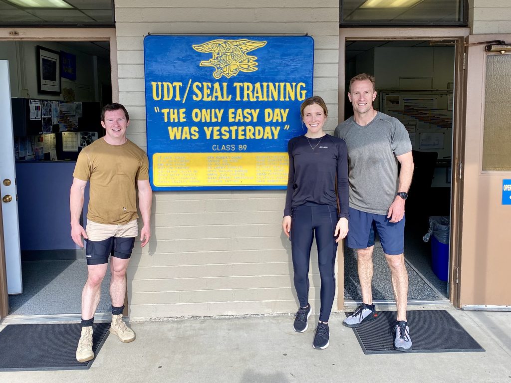 Kristen posing in front of the UDT/Seal Training sign.