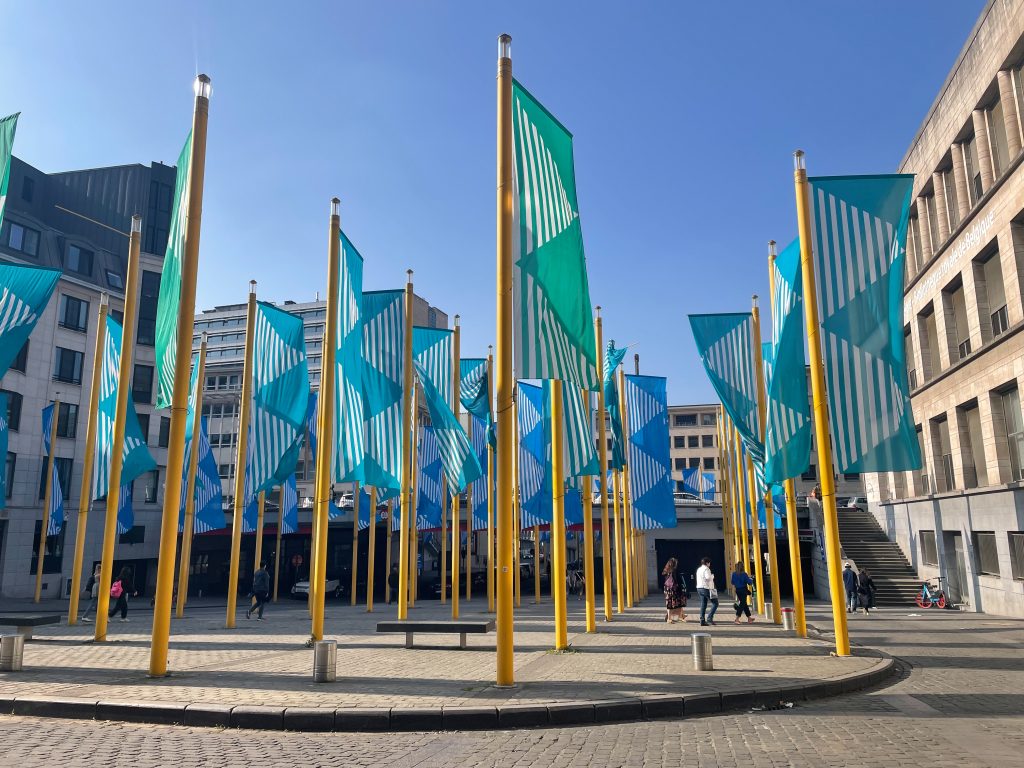 A display of flags that are all on a golden poll